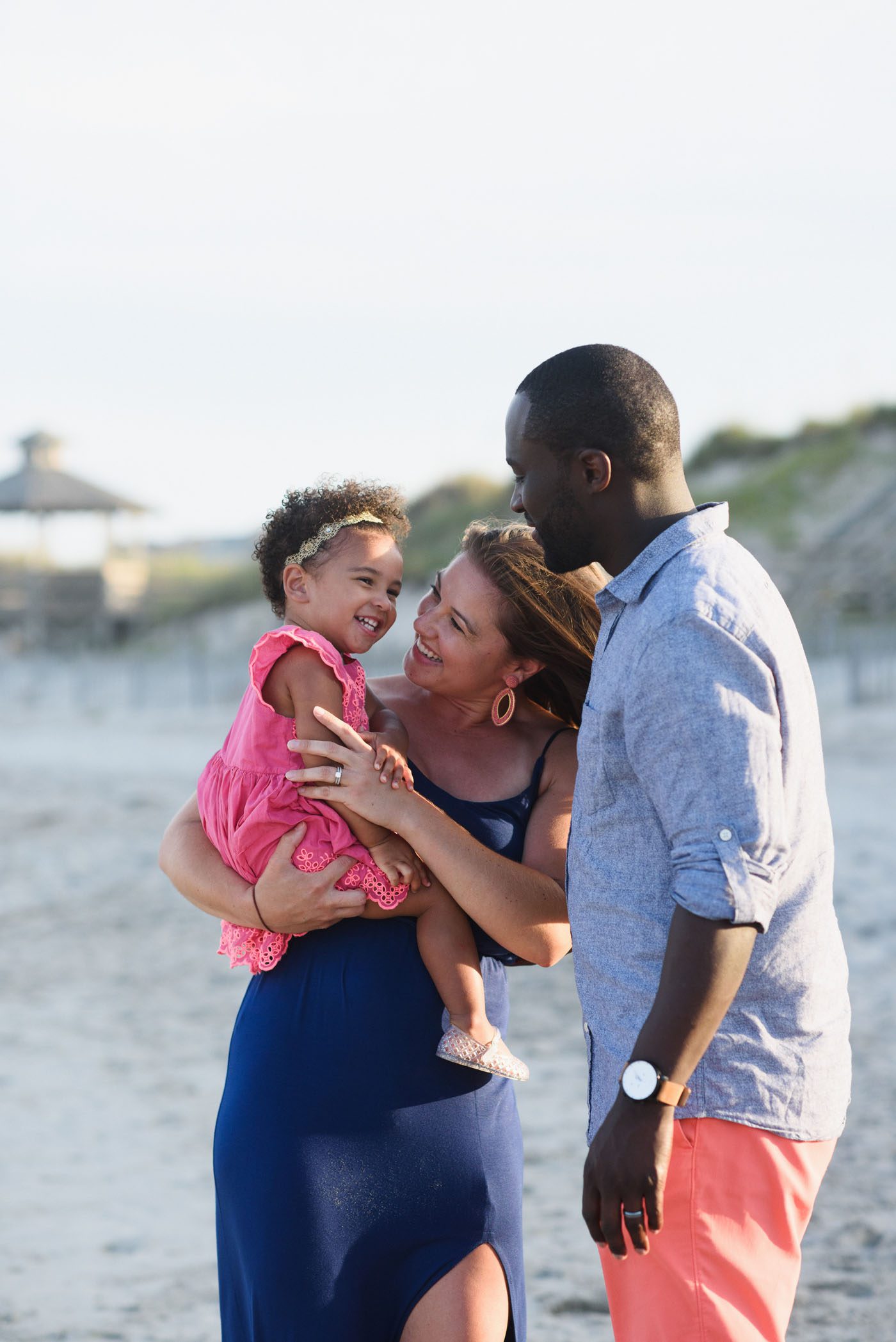 Family laughing together in Corolla during a portrait session on the Outer Banks