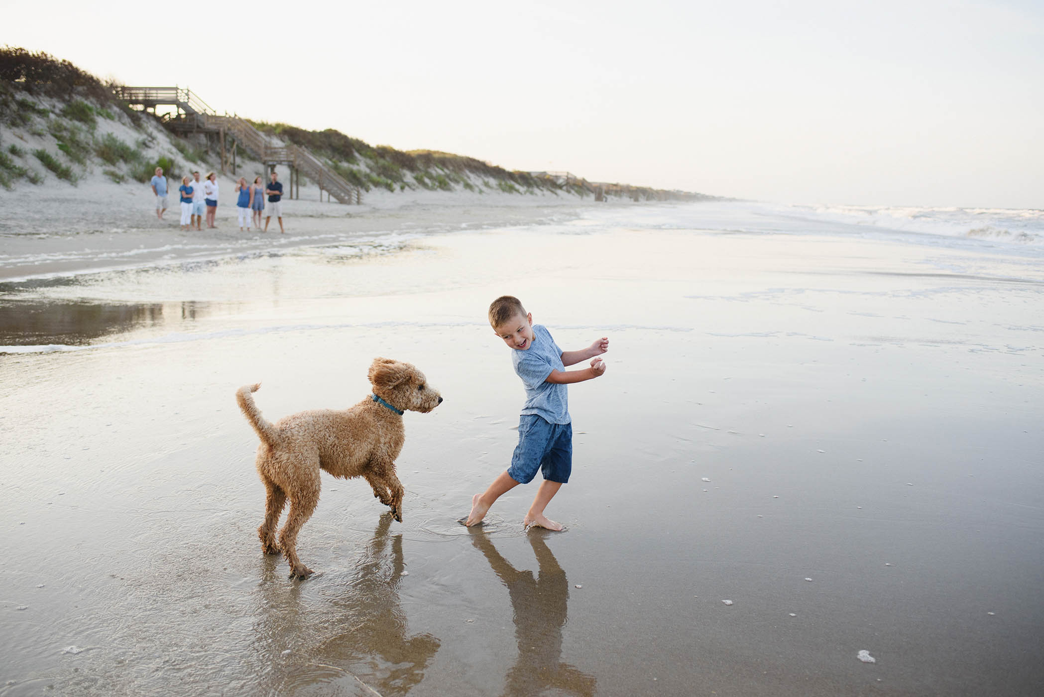 Corolla family portrait photographer with kids and their dog on the beach in the Outer Banks