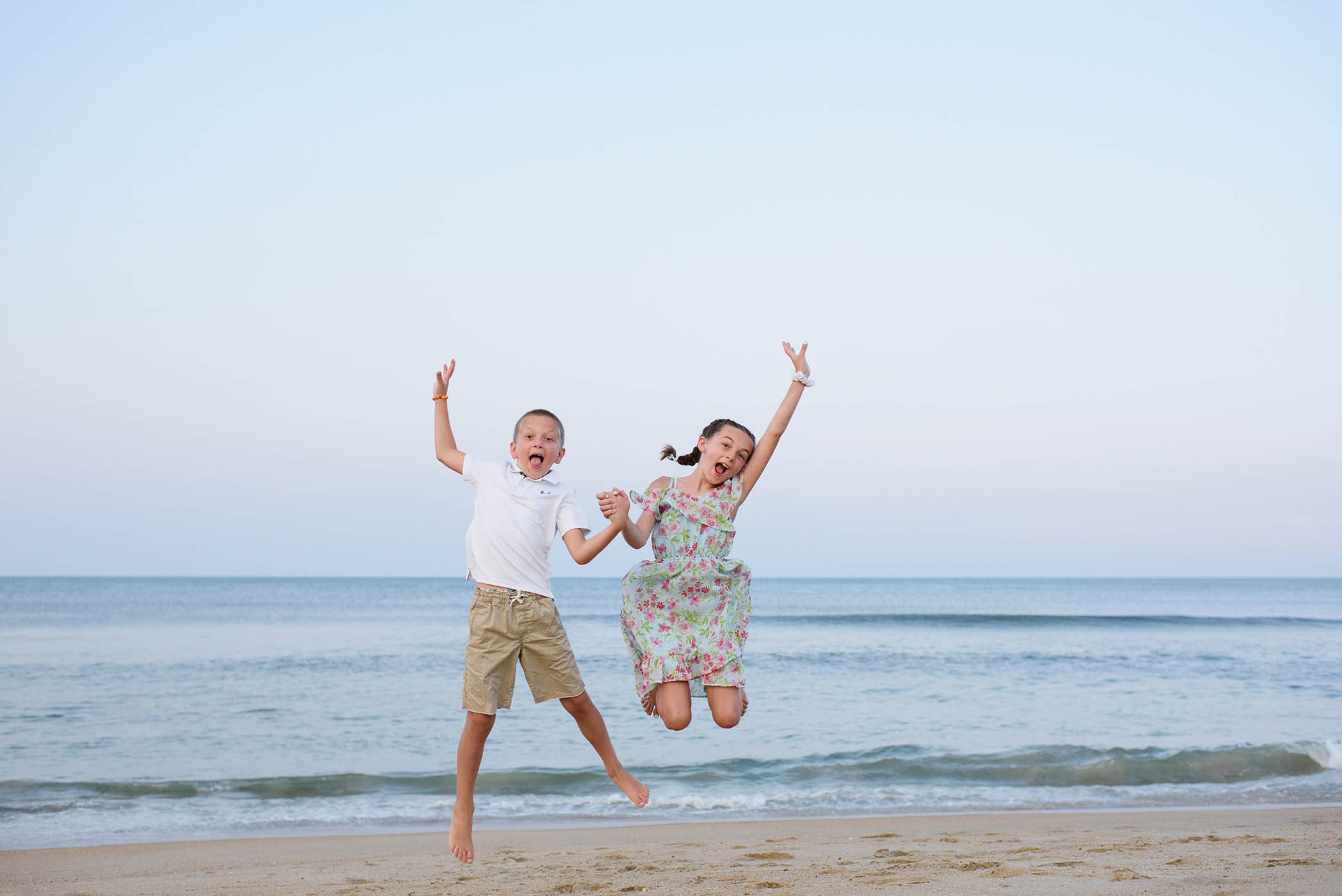 Kids jumping on the beach at an Outer Banks Portraits Session at the Sanderling Resort
