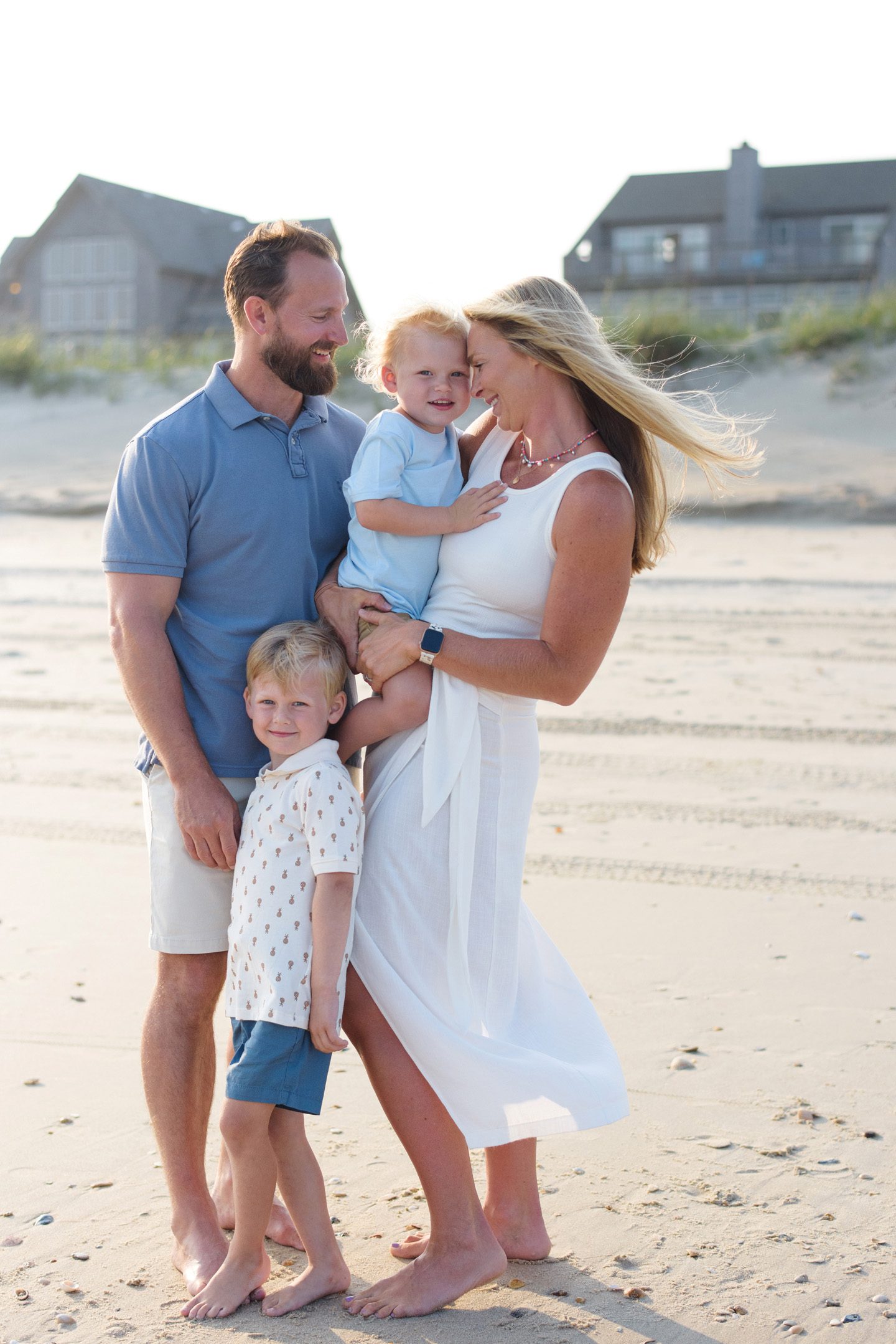 What to wear guide, a family wearing a blue and white color scheme for their Outer Banks family portraits