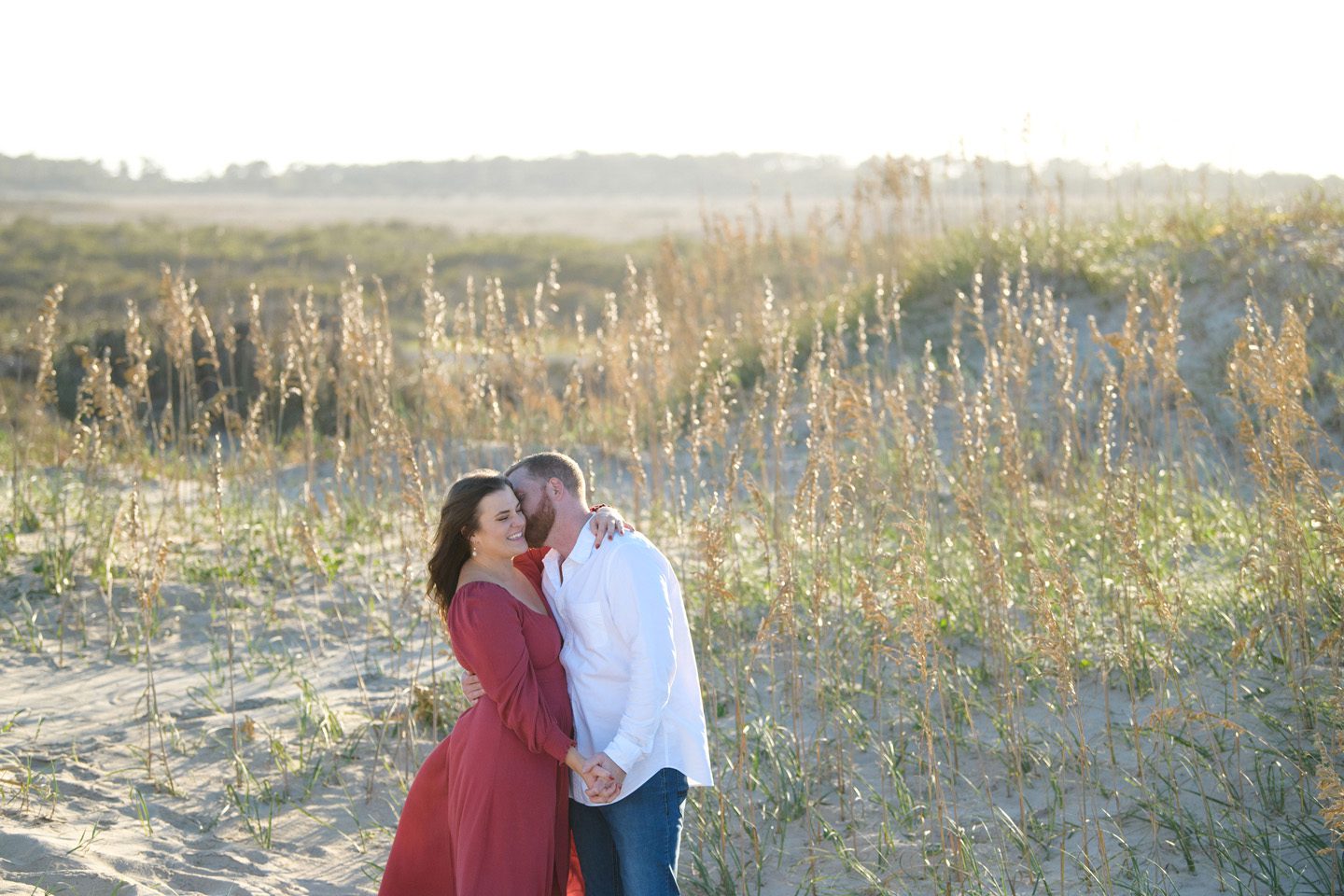 A couple wearing blue and white combined with a highlight color for their Outer Banks portraits