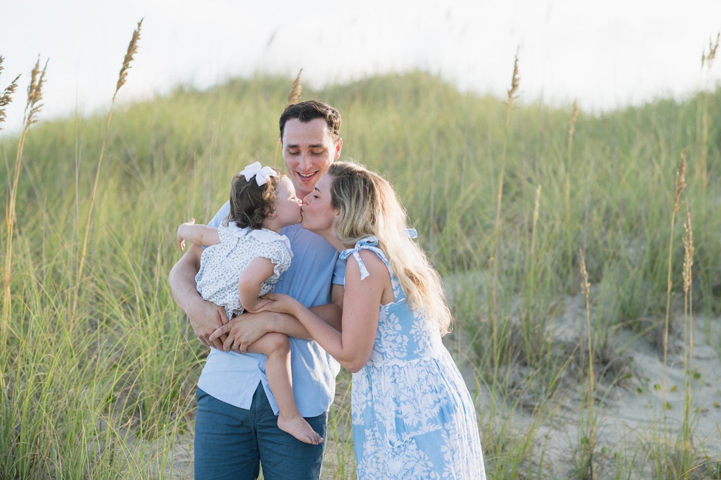 A family enjoying a family portrait session in Nags Head on the Outer Banks