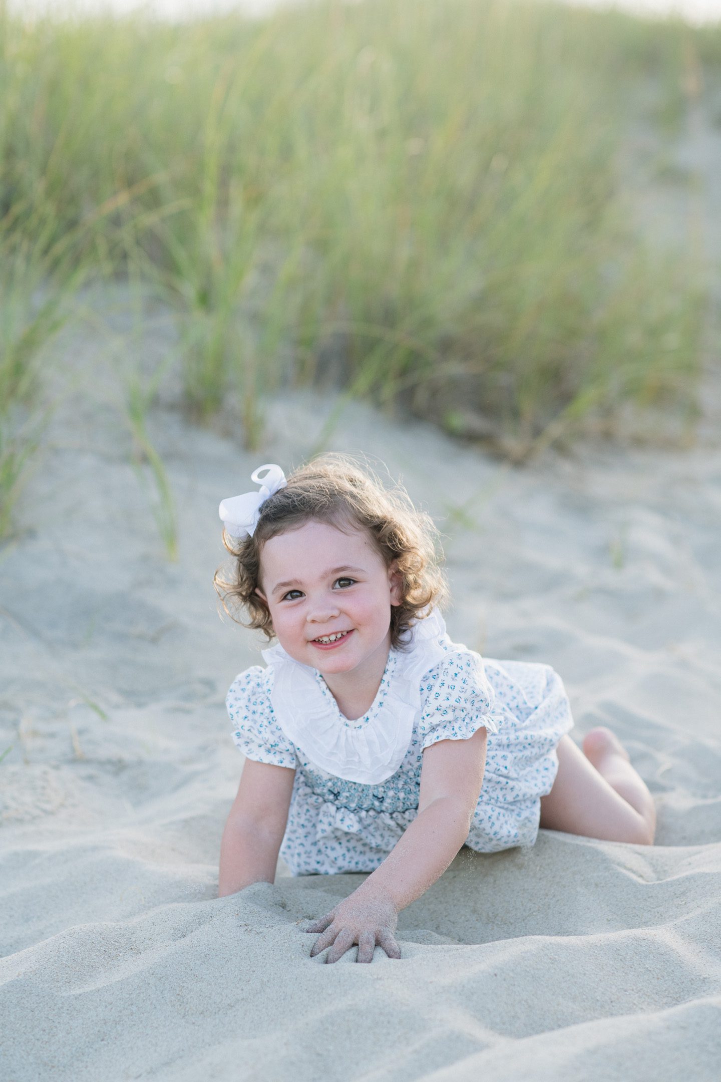 Children enjoying a family portrait session on the beach in Nags Head