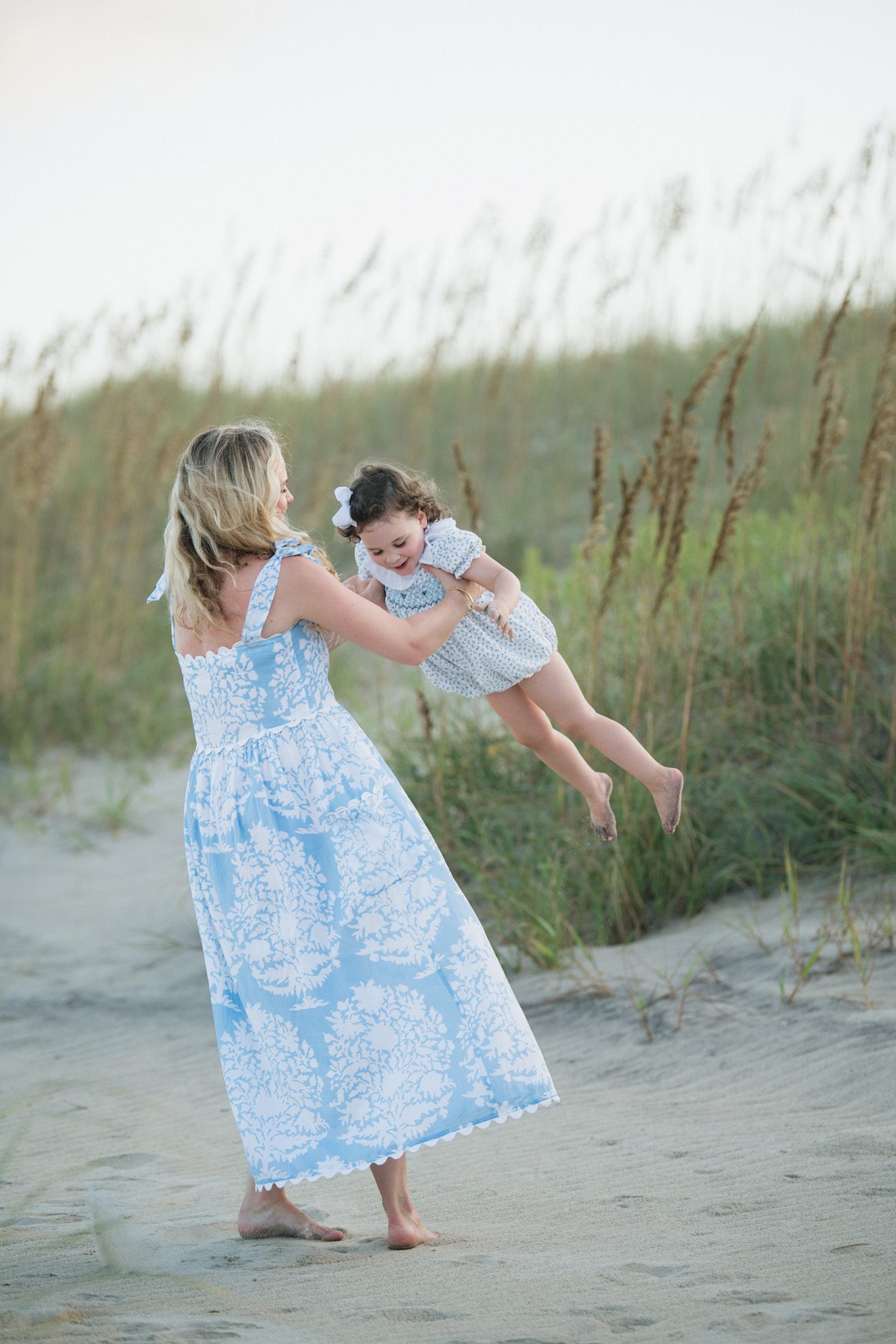 A mother and daughter playing together on the beach in Outer Banks